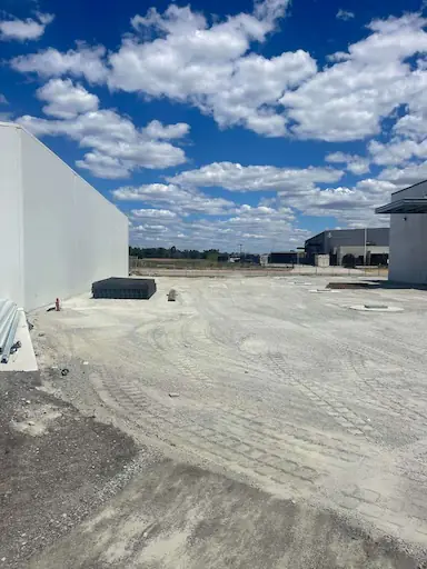 Slab preparation earthworks outside a commercial depot building